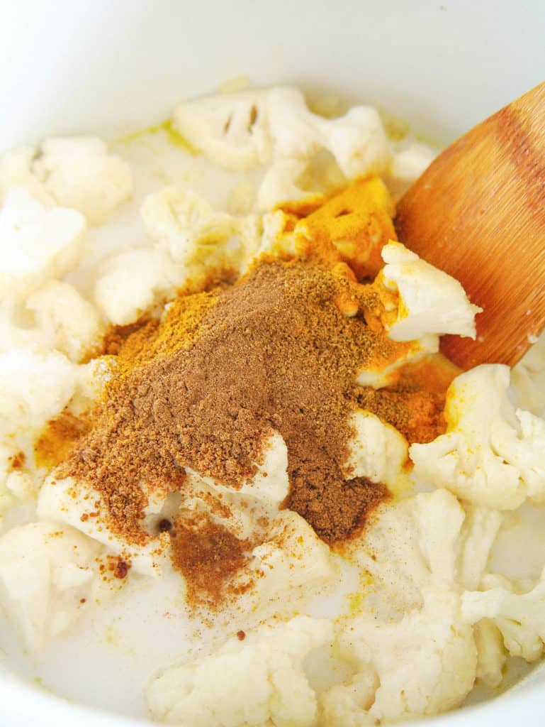 Spices added to cauliflower mixture in the pot.