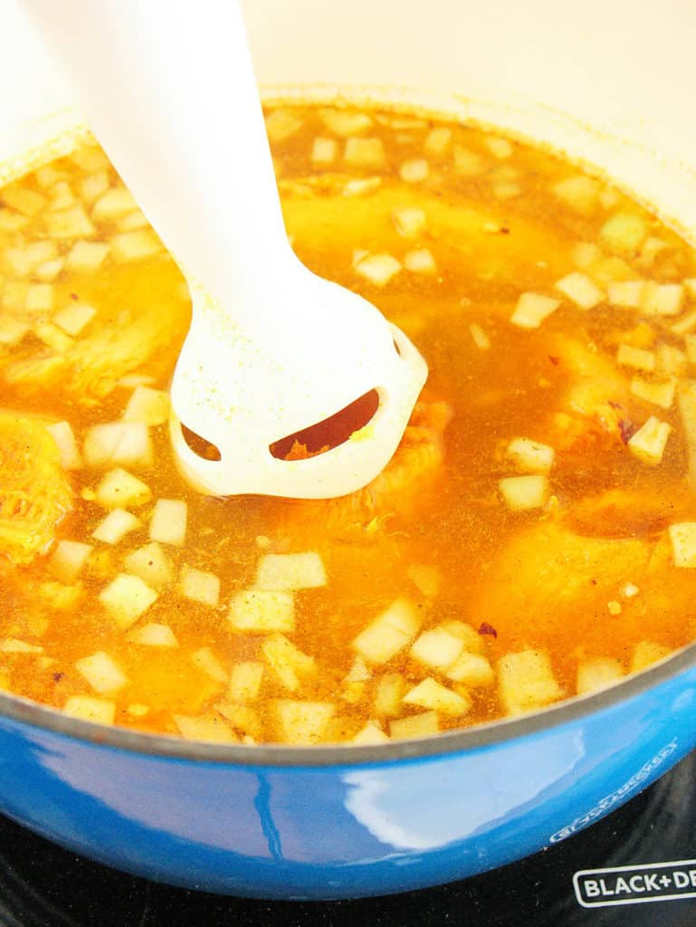 immersion blender going into sweet potato soup