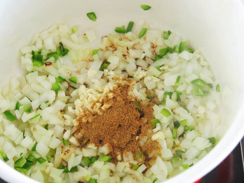 onions jalapeno and spices sauteeing in a pot