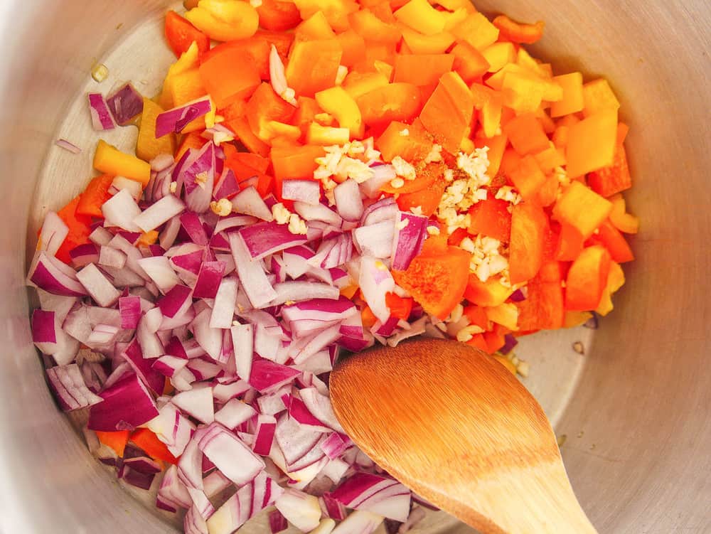 peppers and onions sauteeing in a pot