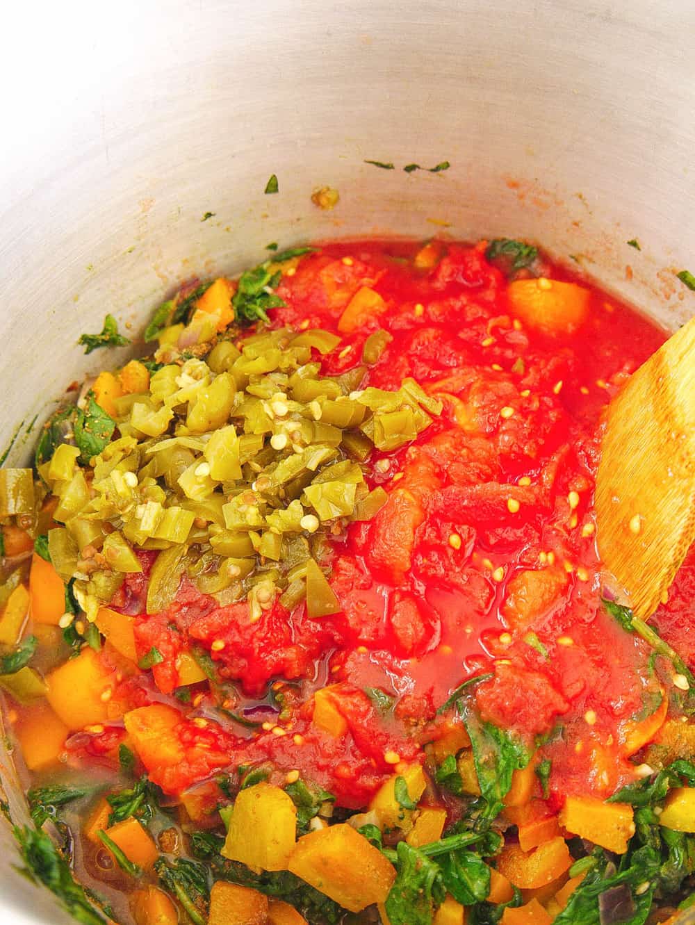 tomatoes and chiles added to pot