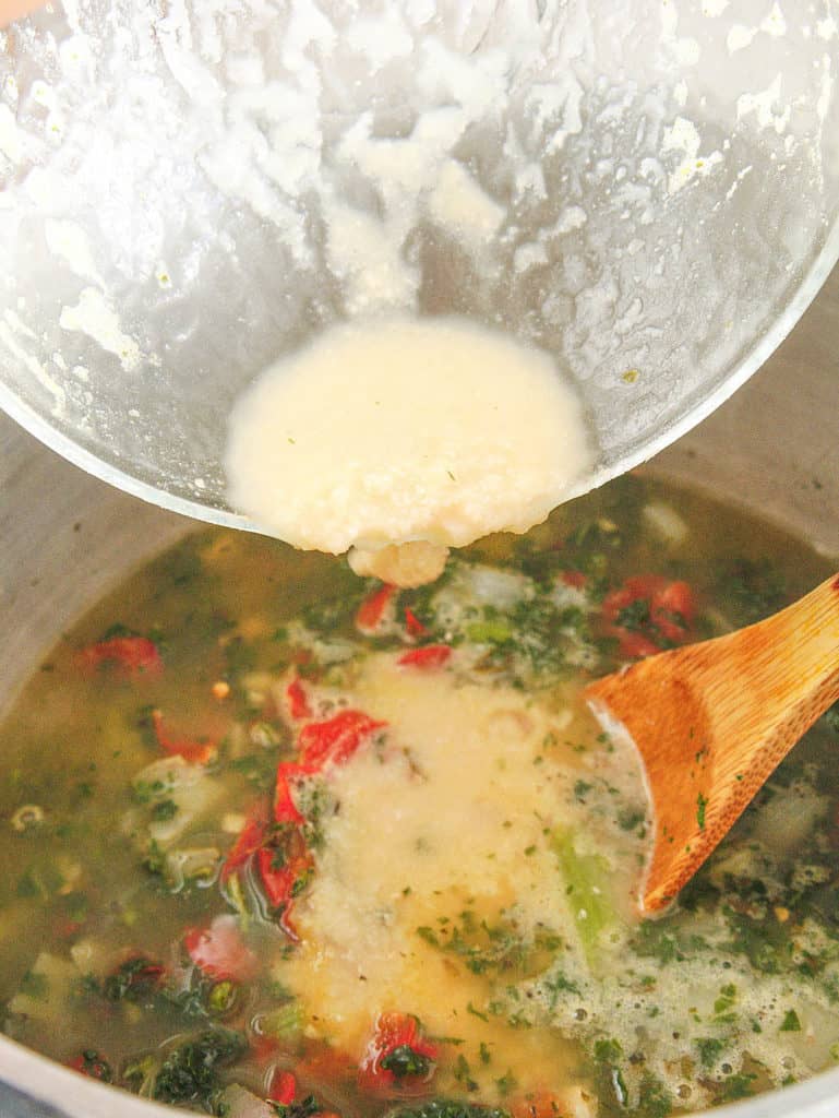 pureed beans being added to soup