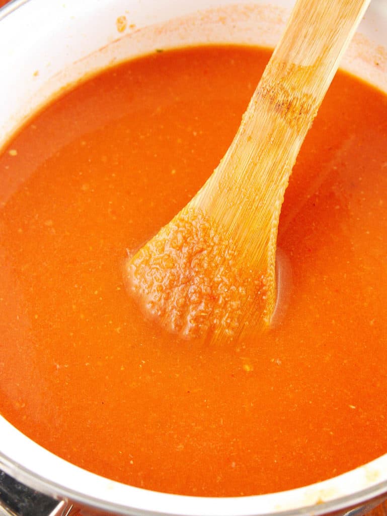pureed taco soup in a pot with wooden spoon
