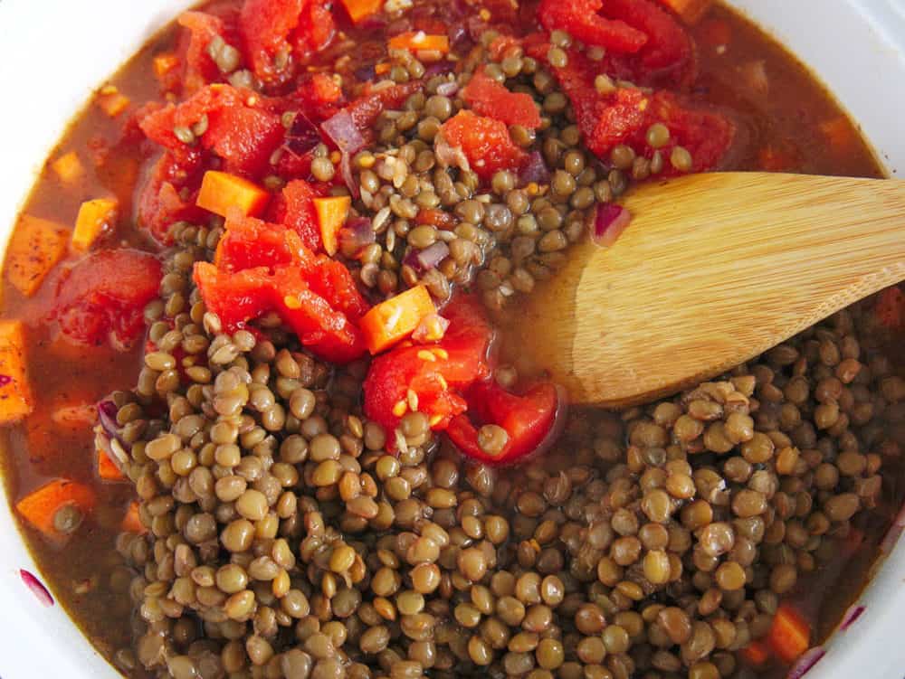 lentils and tomatoes added to pot