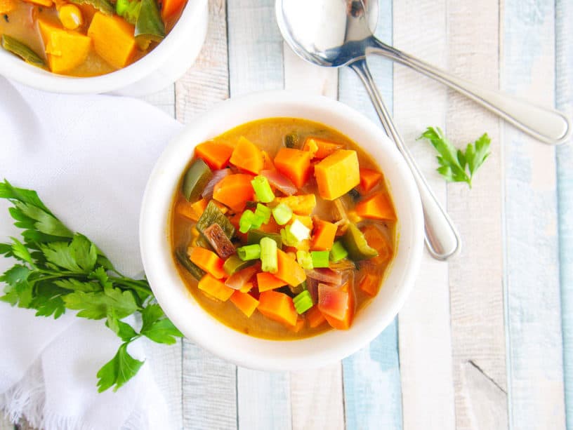 thai sweet potato soup with poblano peppers served in a white bowl, top view