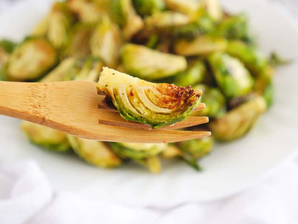 fork holding up air fryer brussel sprouts