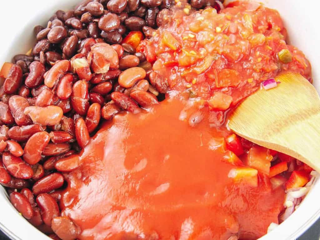 Beans, salsa and tomato sauce combined in a pot.