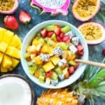 Mexican Fruit Salad with cubed melon, mango, jicama, dragon fruit, lime juice, and a hint of spicy chili - served in a blue bowl