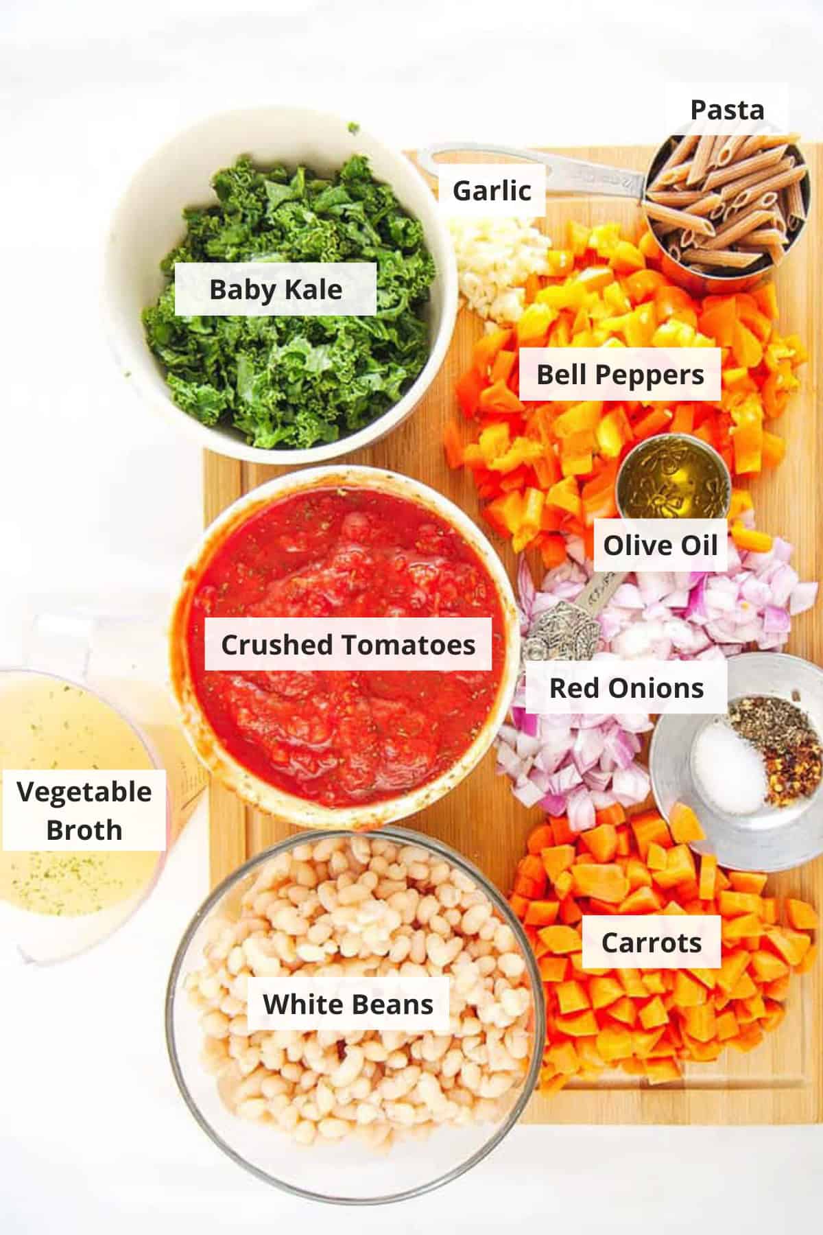 Ingredients for Tuscan white bean stew recipe on a white countertop. 