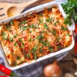 vegetarian enchilada casserole, in a baking dish with the ingredients on the table