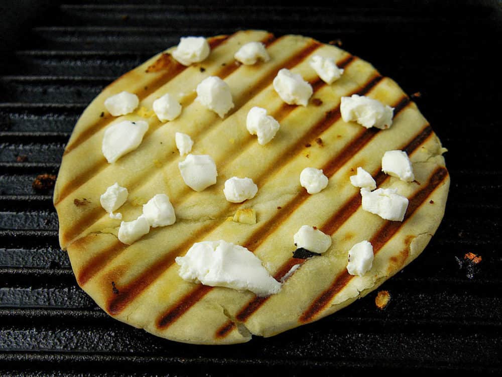 pita bread grilled with goat cheese on top