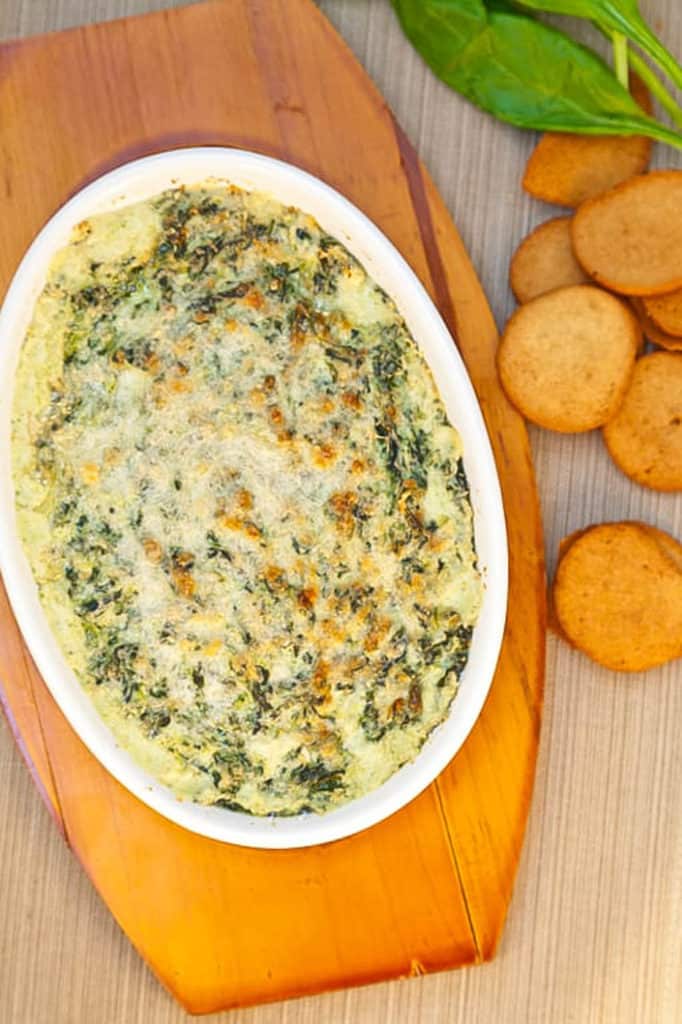 Healthy Cheese Dip with Smoky Onion and Kale served in a white baking dish
