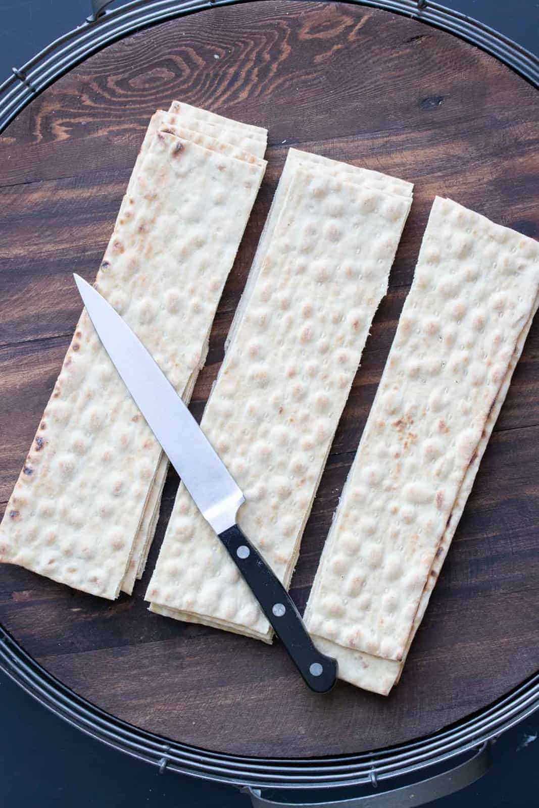 These vegan pinwheels are the perfect snack! Super kid friendly, versatile and easy enough the littles can make them too! #ad #vegansnacks #kidsrecipes Knife on top of sliced pieces of lavash bread