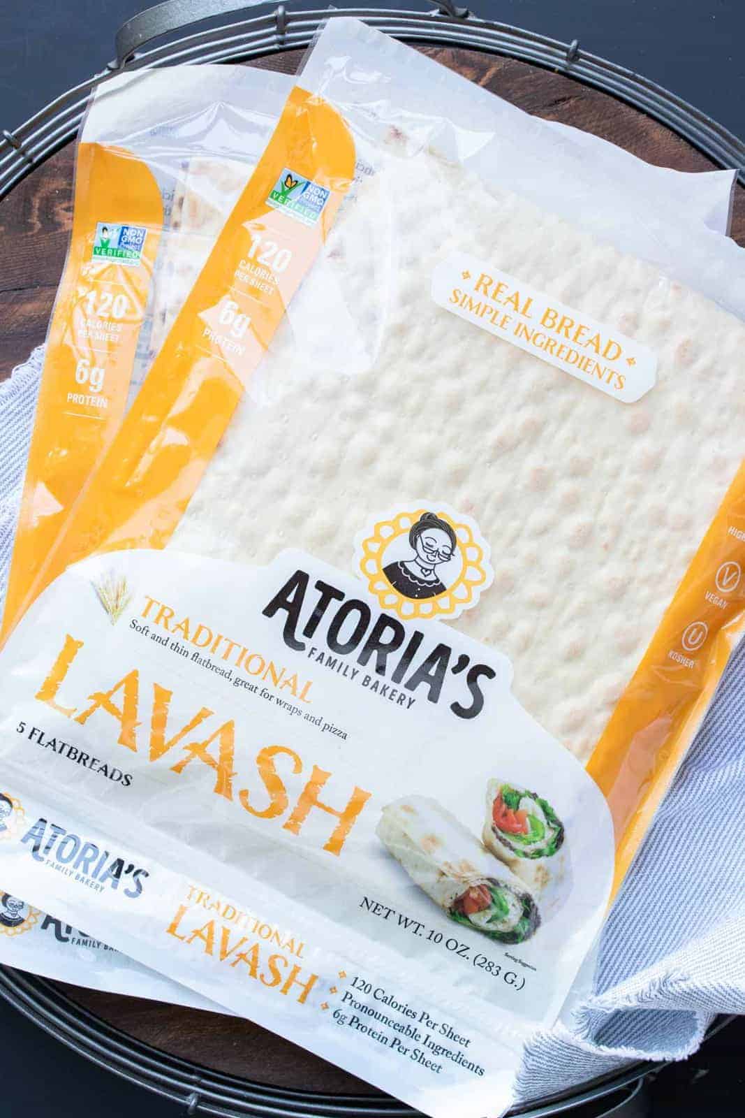 These vegan pinwheels are the perfect snack! Super kid friendly, versatile and easy enough the littles can make them too! #ad #vegansnacks #kidsrecipes Pile of two orange packages of lavash bread