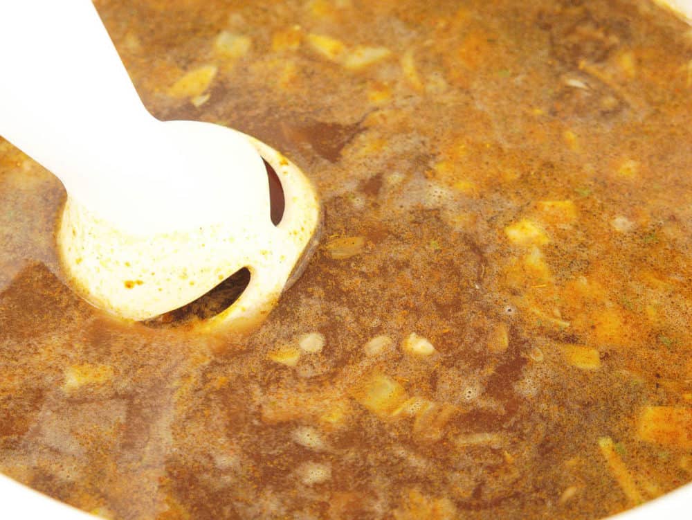 immersion blender blending soup in a pot
