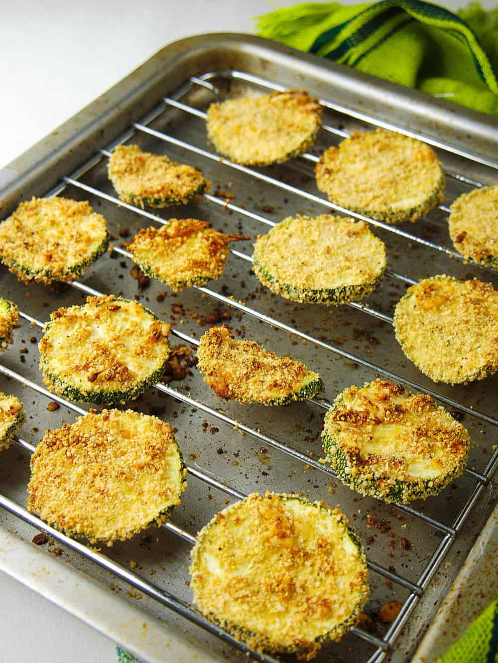 baked and crispy courgette chips with parmesan, fresh out of the oven on a tray