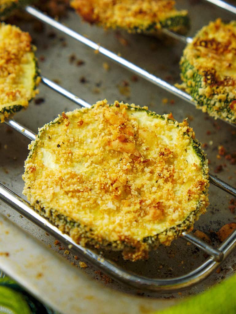 baked and crispy courgette chips with parmesan, fresh out of the oven on a tray