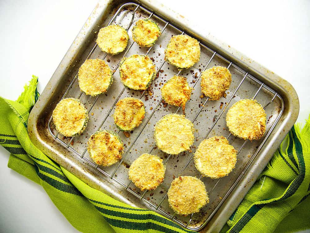 baked and crispy courgette chips with parmesan, fresh out of the oven on a tray