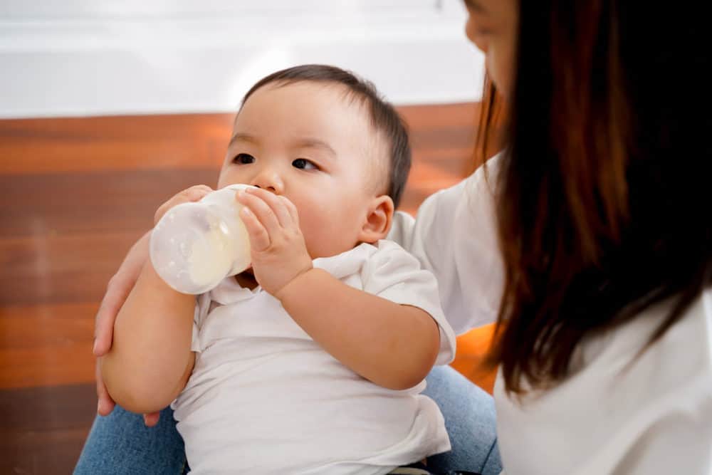 close up of baby drinking loulouka formula