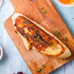 top view of garlic bread grilled cheese on a wooden cutting board