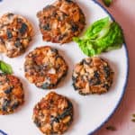 mashed potato fritters with onions and kale, served on a white plate, top view