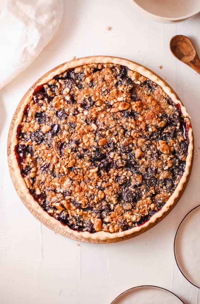 cherry crumb pie against a white background, top view