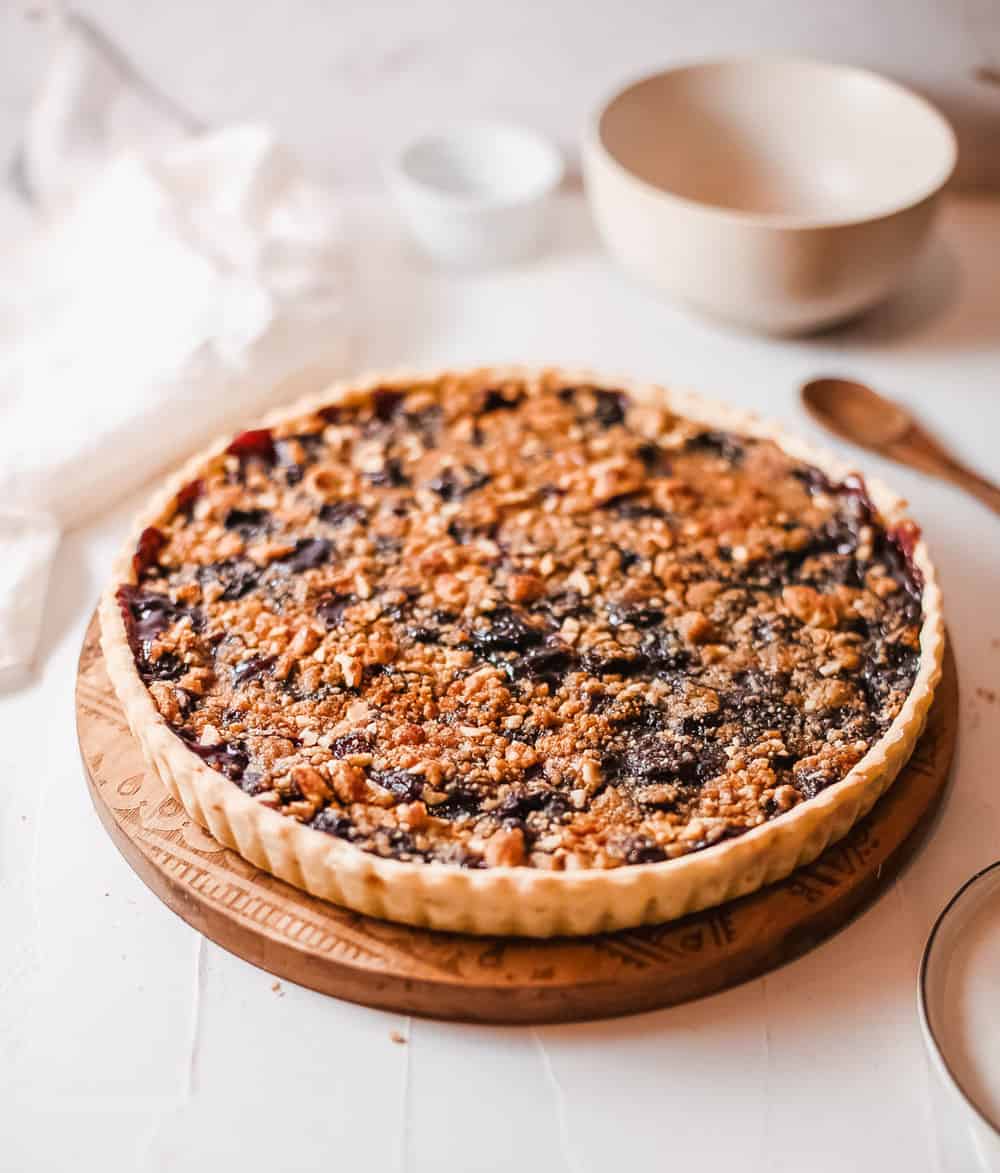 cherry crumb pie against a white background, side view