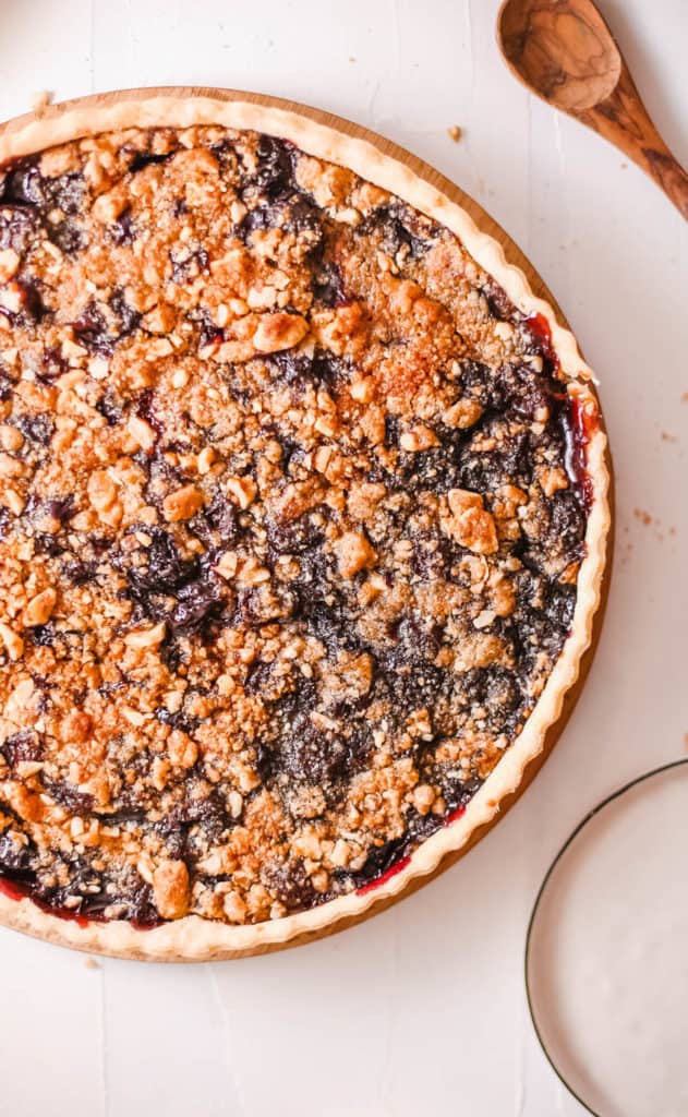 cherry crumb pie against a white background, top view