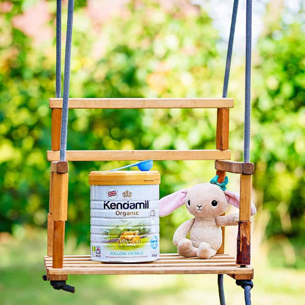 kendamil formula container stage 2 on a swing next to a stuffy