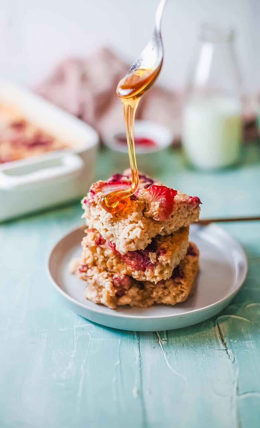 maple syrup drizzled on squares of vegan baked oatmeal