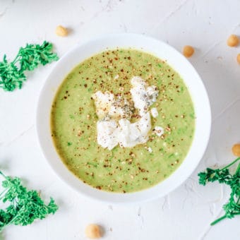 asparagus and leek soup with herbed goat cheese served in a white bowl