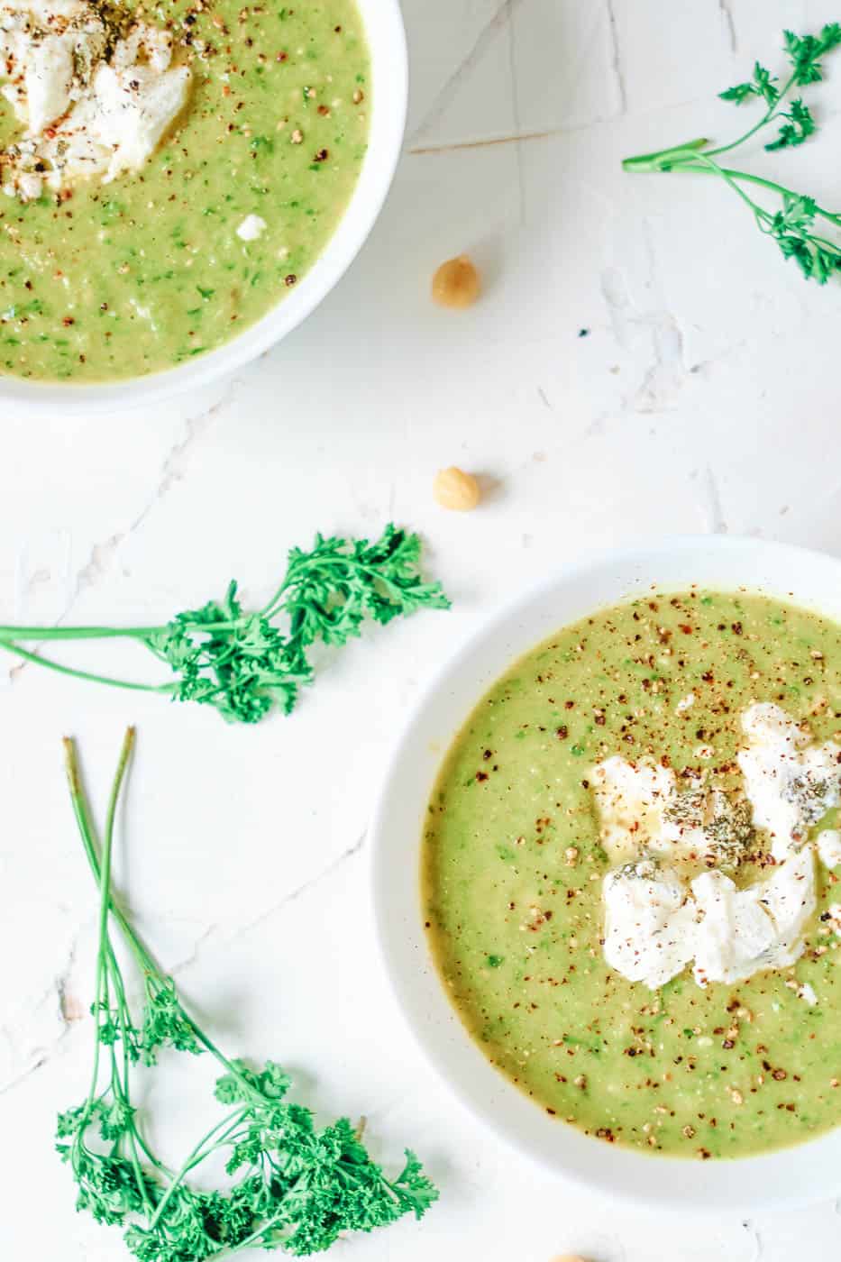 asparagus and leek soup with herbed goat cheese served in a white bowl