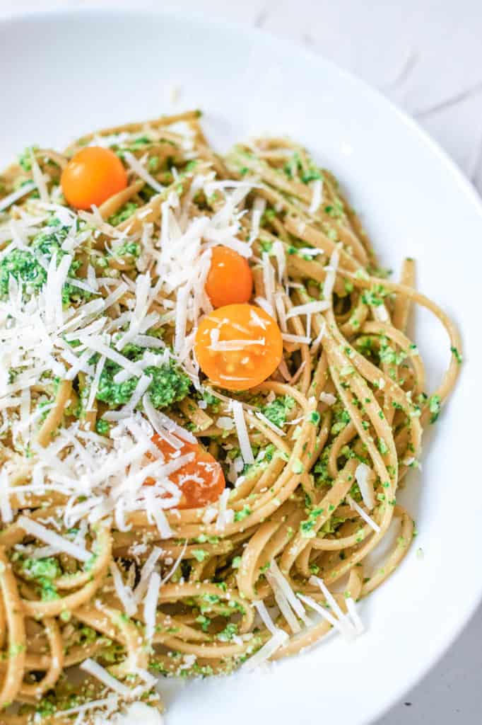 vegetarian pesto pasta with spinach and herbs, served on a white plate - 30 minute vegetarian meals