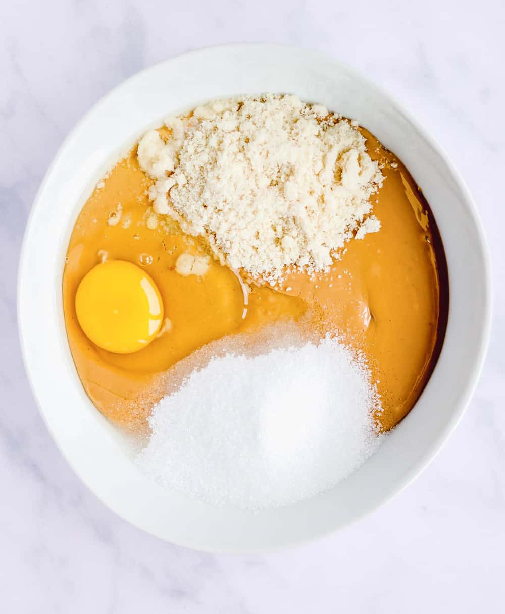 iIngredients mixed together in bowl - eggs, flour, peanut butter.