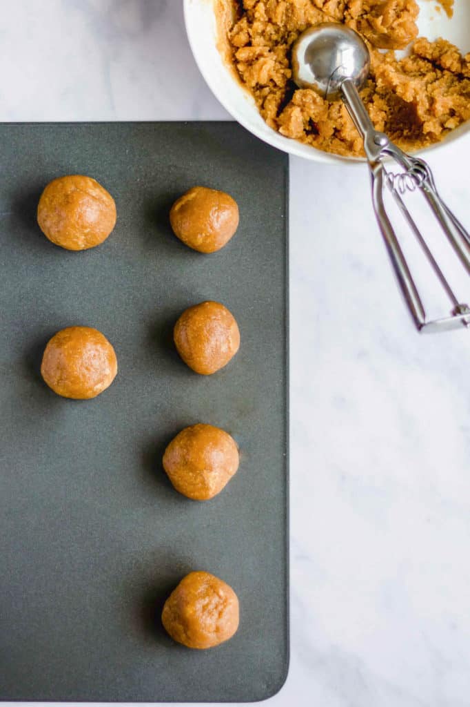 cookie dough balls on baking sheet