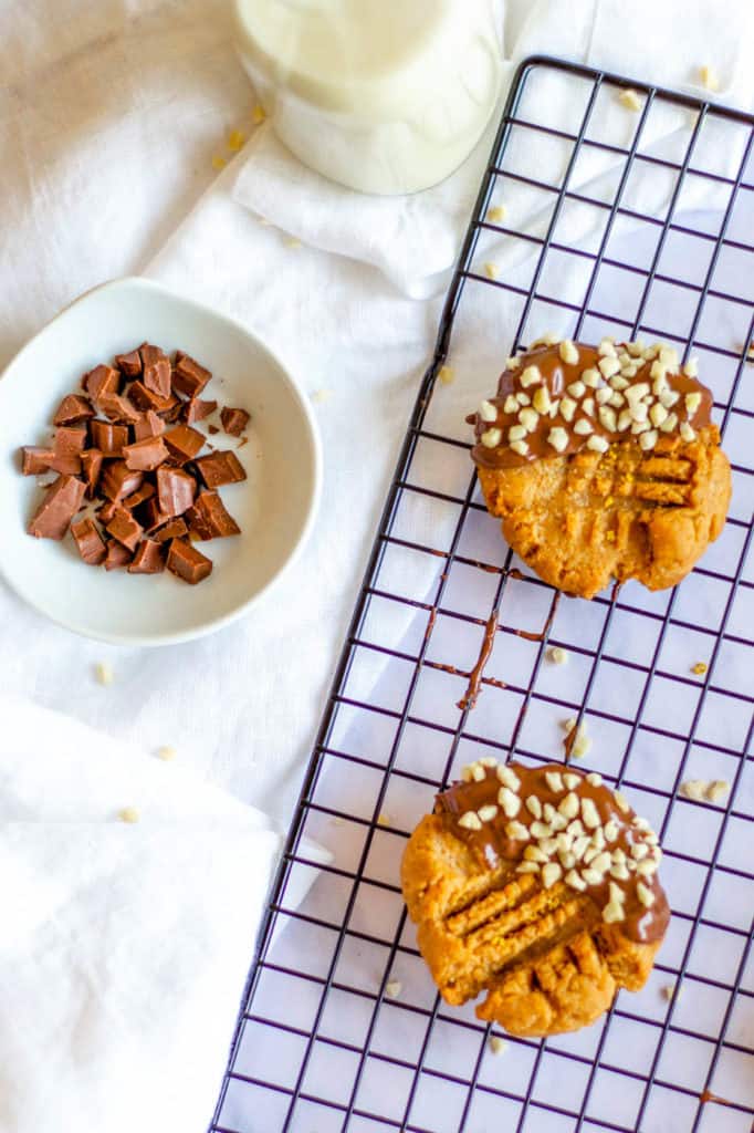Keto Peanut Butter Cookies dipped in chocolate and nuts, on wire rack