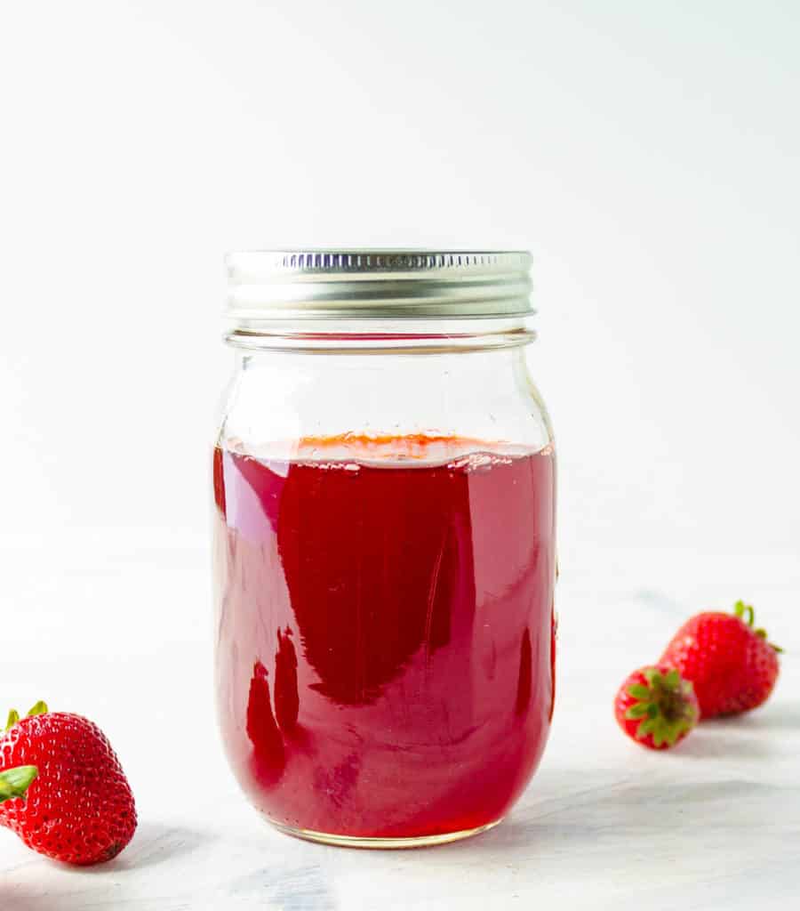 Strawberry Simple Syrup in a mason jar