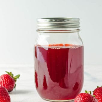 strawberry simple syrup in a mason glass jar