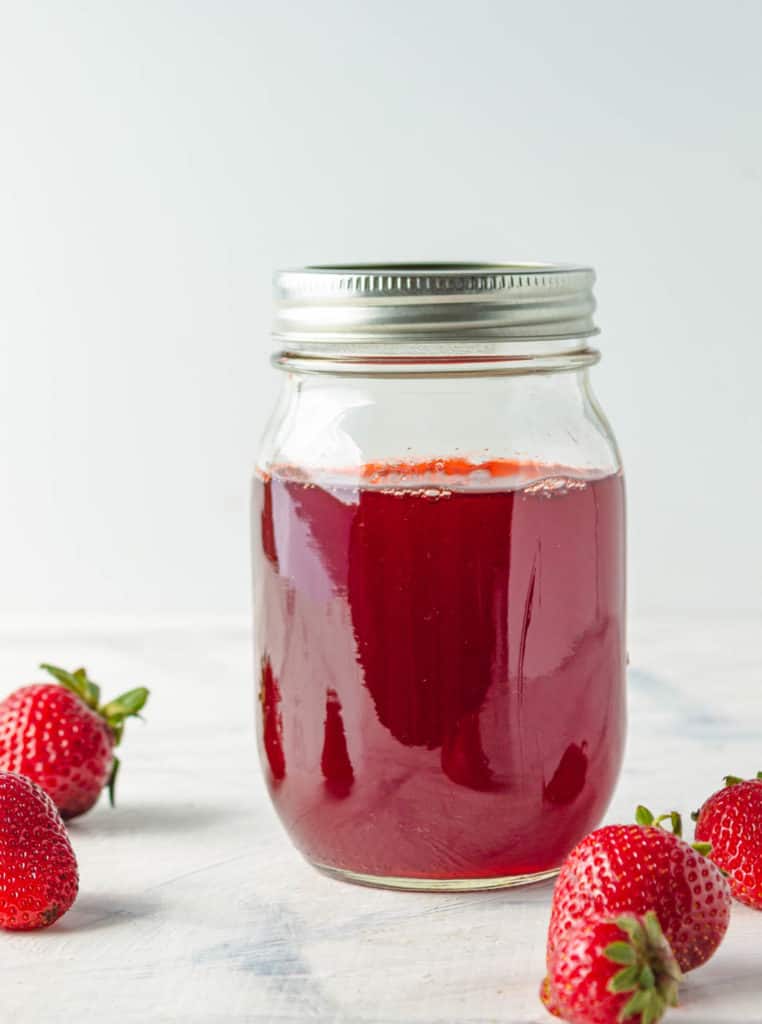 strawberry simple syrup in a mason glass jar