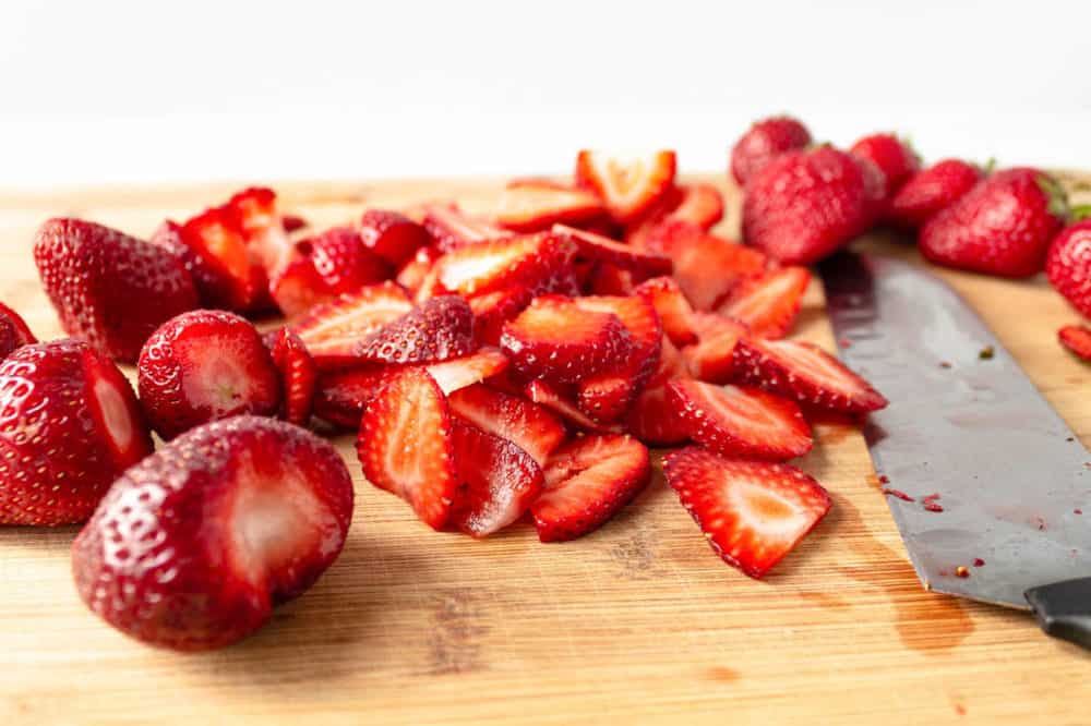 cut strawberries on a cutting board