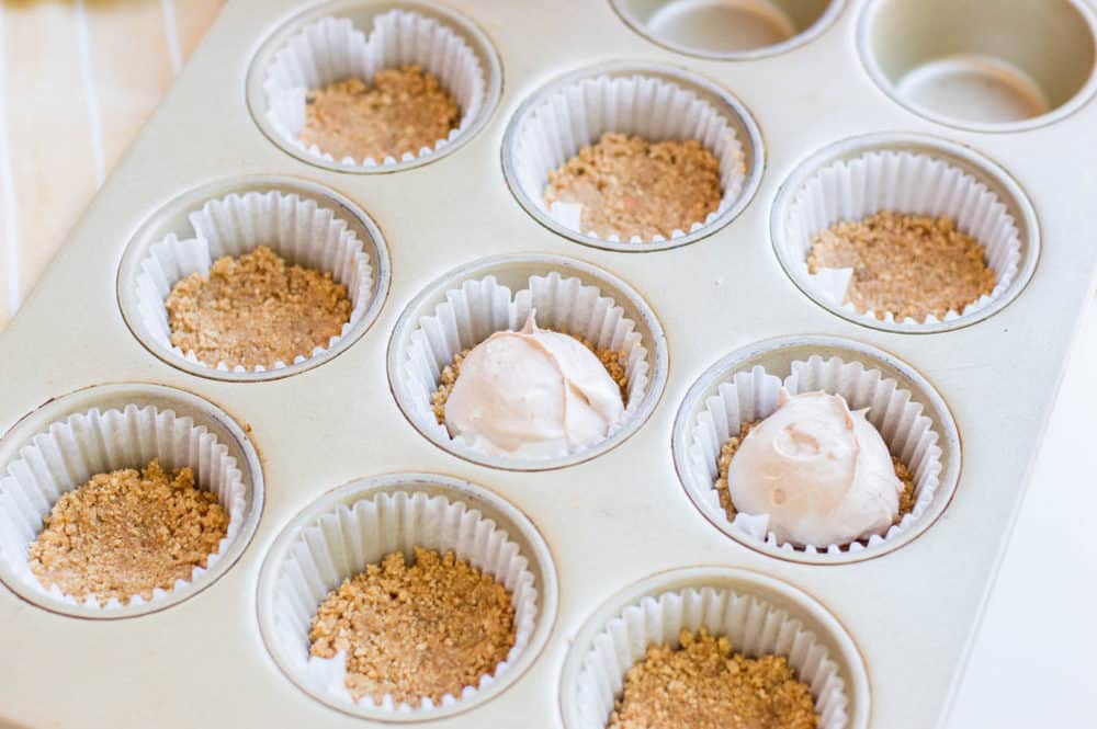mini cheesecakes going into the muffin tins