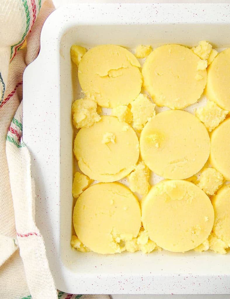 Polenta slices in a baking dish.