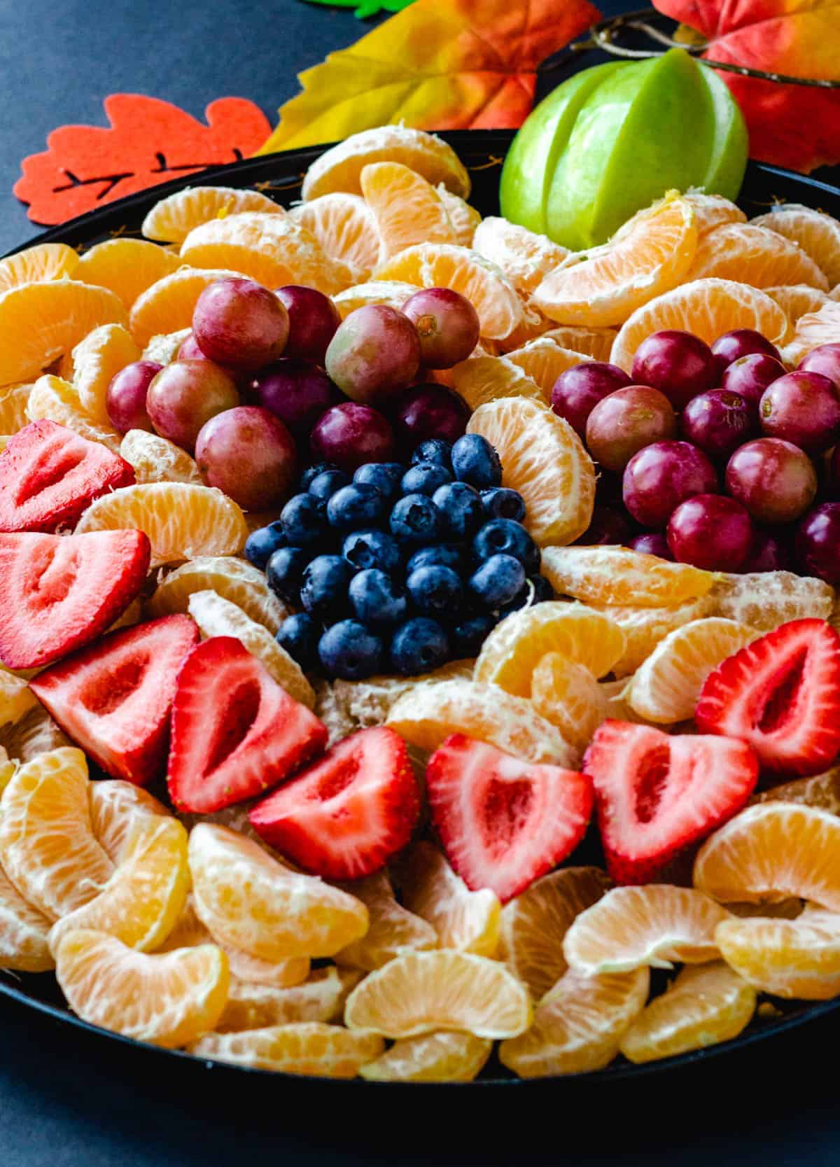 fruit arranged in a the face of a jack-o-lantern
