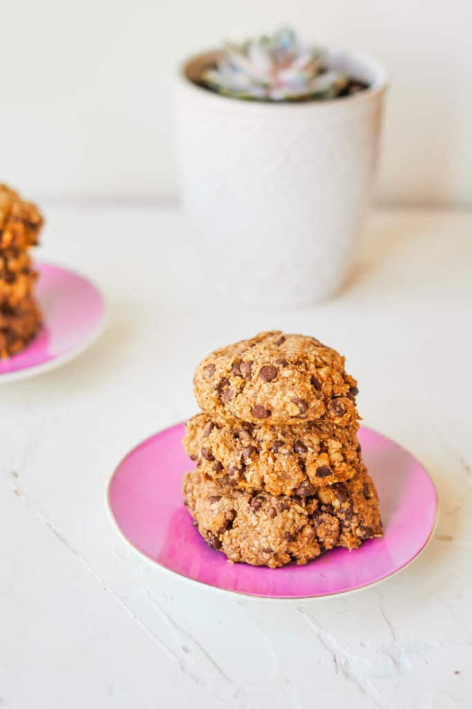 Vegan Oatmeal Cookies with Chocolate Chips stacked on a pink plate