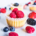 closeup of cheesecake bites topped with fresh raspberries