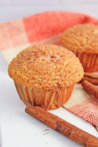 cinnamon muffins fresh out of the oven against a white background