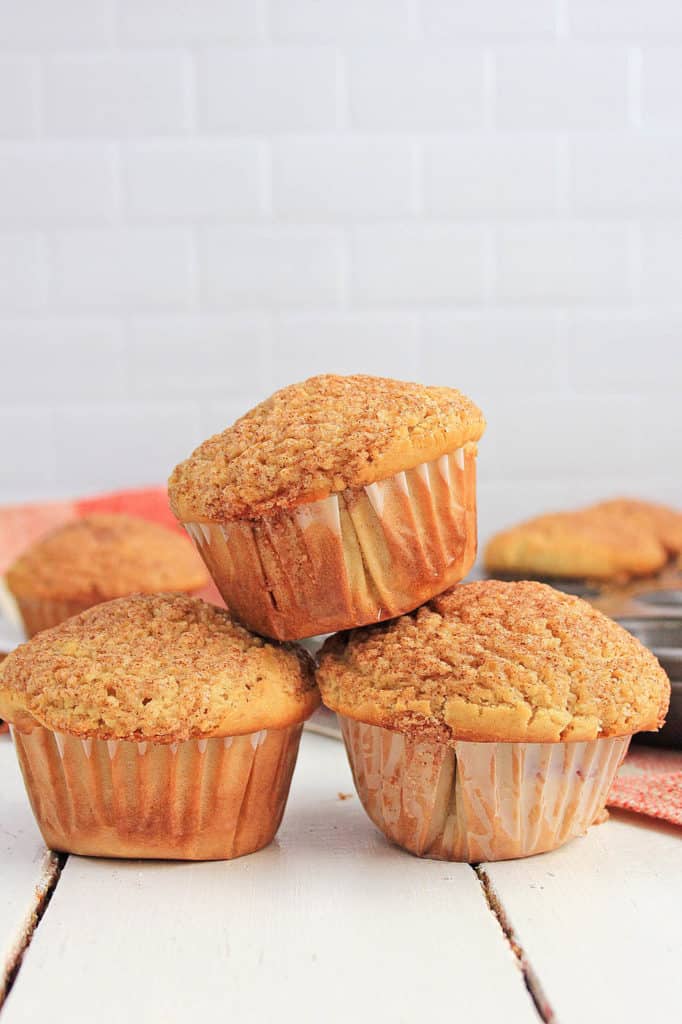 cinnamon muffins stacked on top of each other against a white background