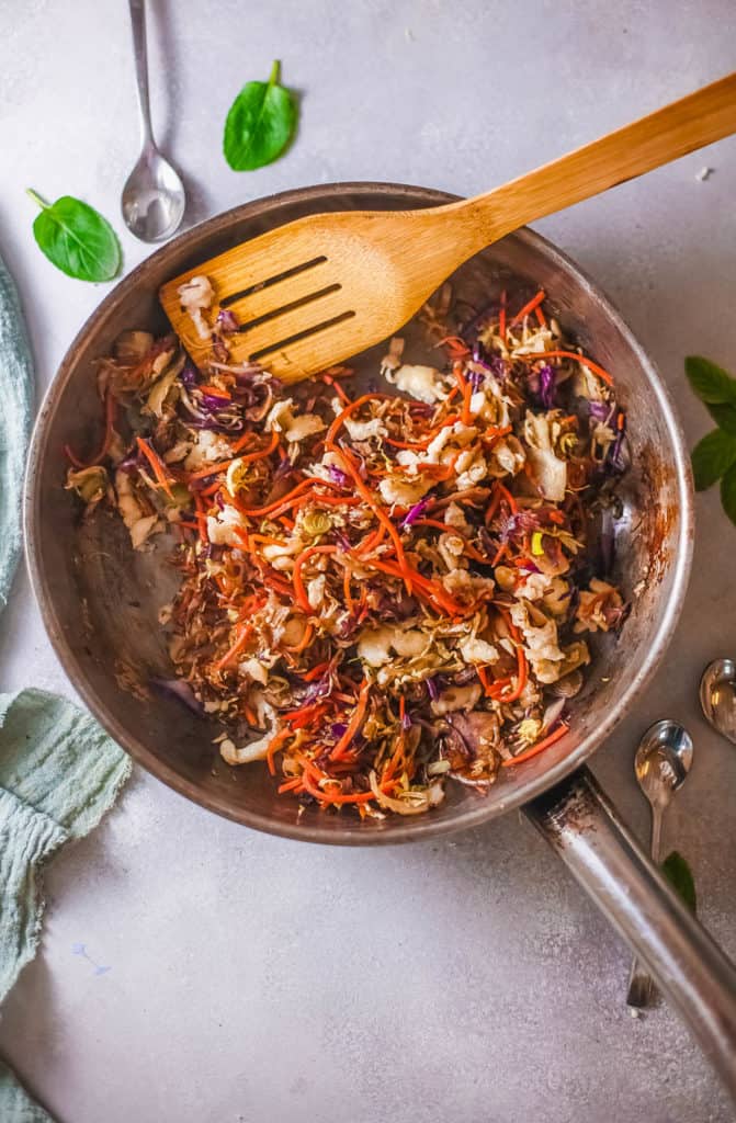 tofu added to cabbage in a pan
