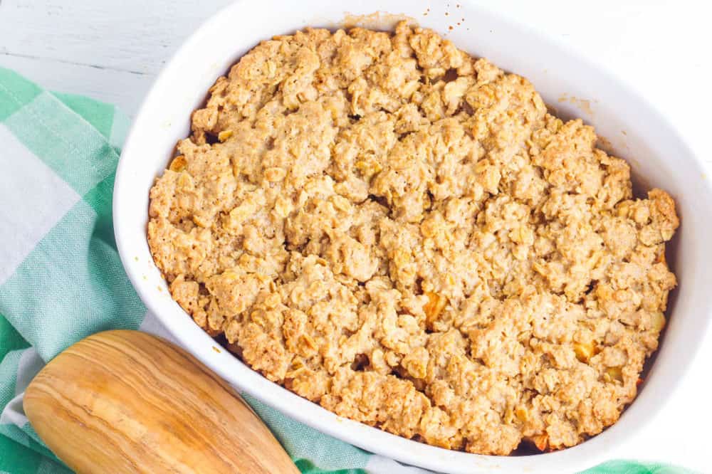 gluten free apple crisp fresh out of the oven in a white casserole dish