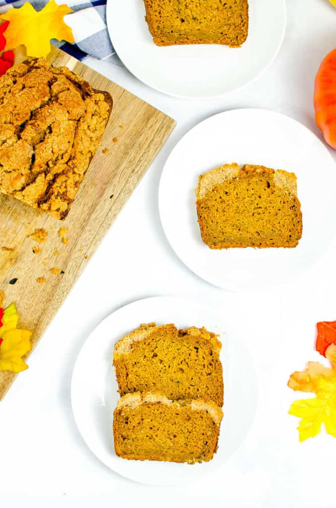slices of gluten free coffee cake with pumpkin on a white plate with full bread loaf in the corner
